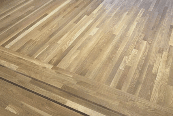 Wide-plank matte hardwood floors in a modern Seattle living room, finished by LUKS Construction for a natural, low-sheen, low-maintenance look.
