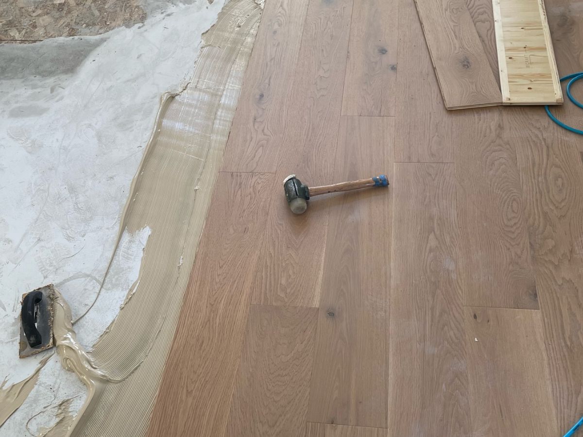 Glue-down engineered hardwood floor installation over concrete in Bellevue WA
