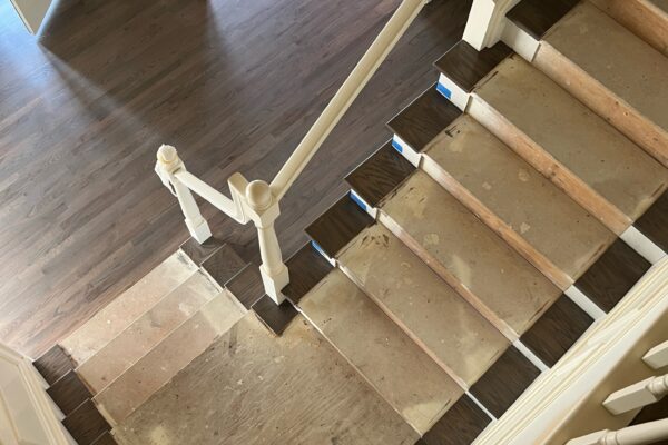 Stairs under renovation, wooden flooring visible.