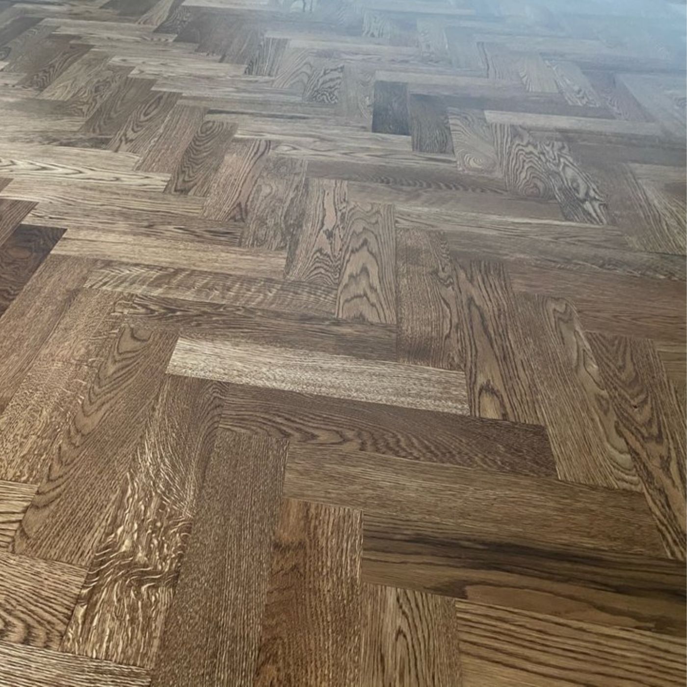 White oak engineered hardwood herringbone installation stained DuraSeal Early American and finished with matte Bona water-based finish by LUKS Construction Seattle Bellevue