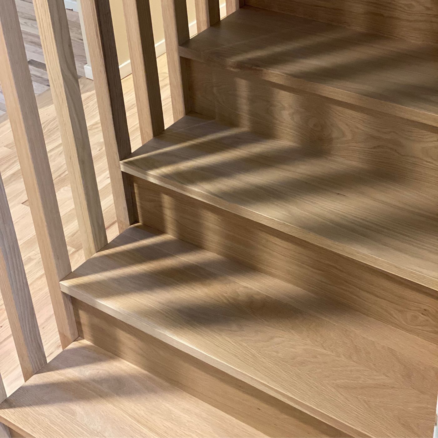 Hardwood stairs refinishing with warm stain and matte finish in Bellevue WA