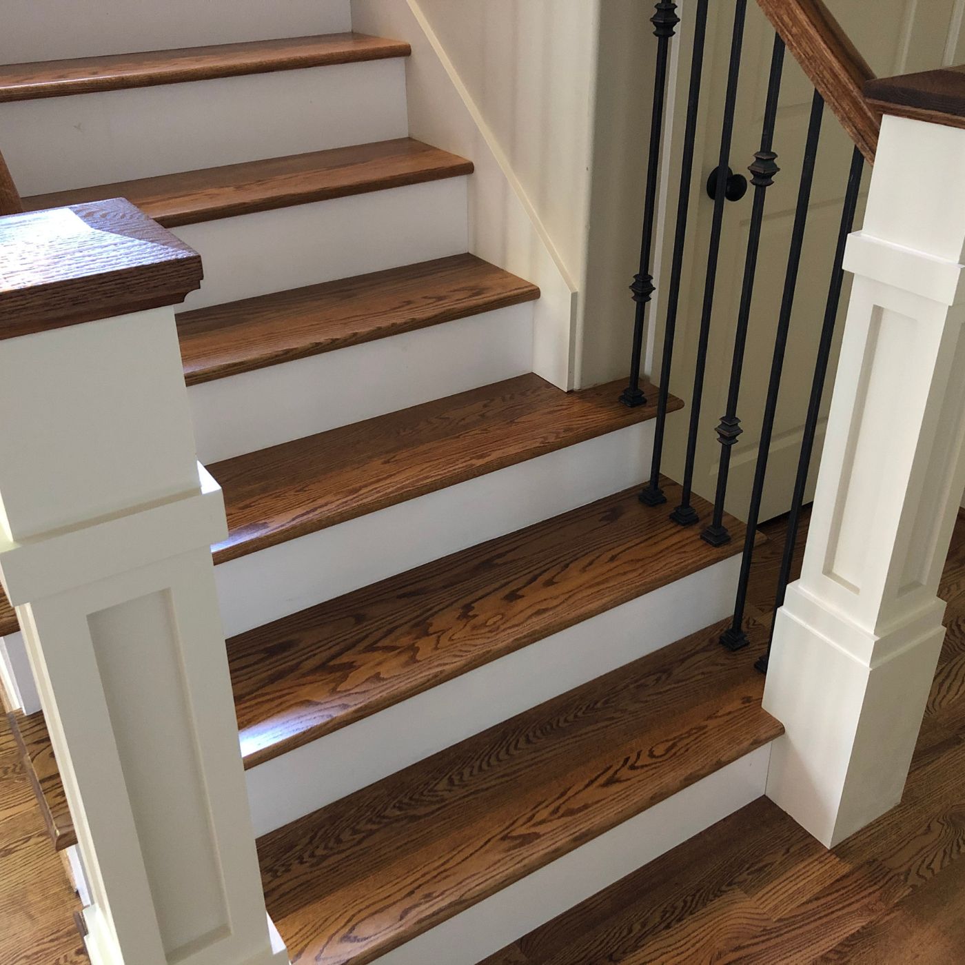 Hardwood stairs landing transition to new floors in Eastside WA