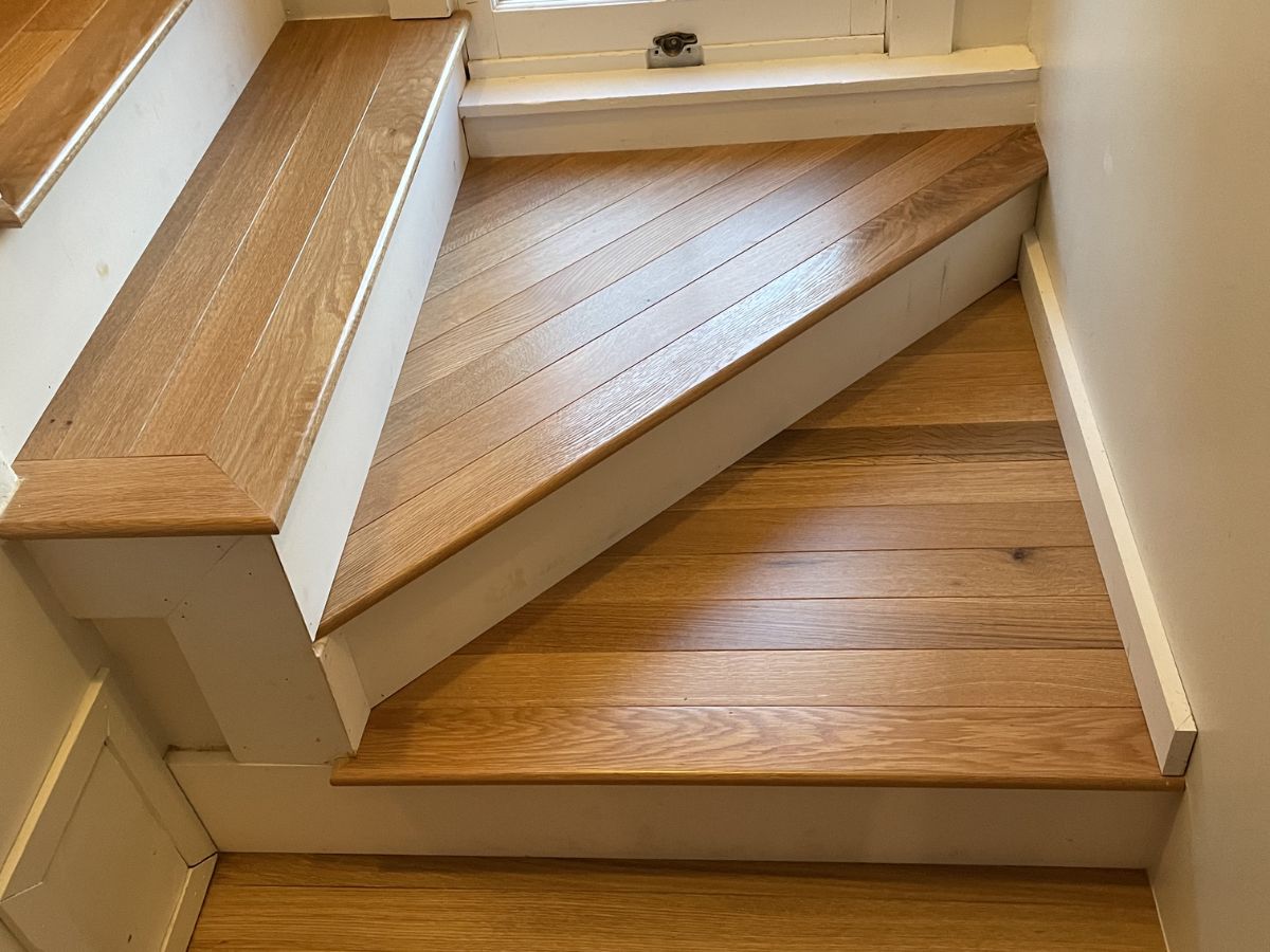 Stair tread overlay installation with clean returns in Redmond WA